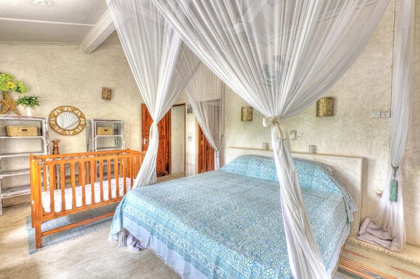 Bedroom 3 with canopy bed and wooden cot