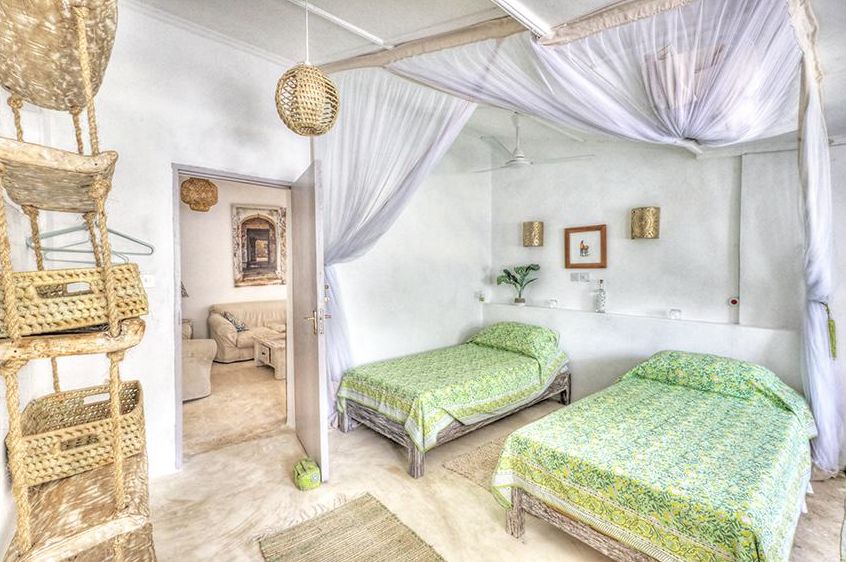 Bedroom 5 with twin beds in green linens